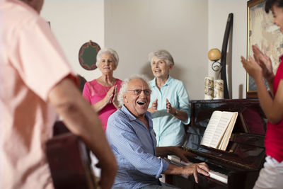 Elderly people making music in retirement home