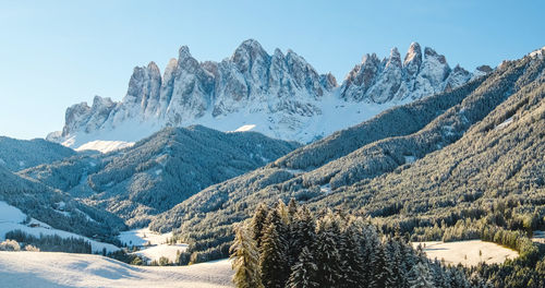 Alpine mountains with white snow and blue sky in dolomites ski resort in tyrol, italy.