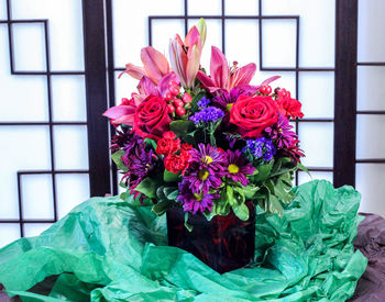 Close-up of pink roses on window