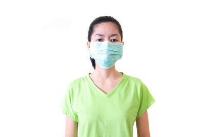 Portrait of a young woman wearing hat against white background