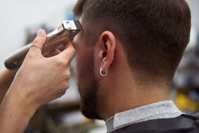 Close-up portrait of young man using mobile phone