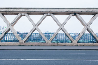 Bridge over road against sky in city