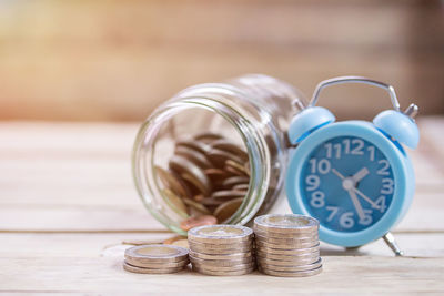 Close-up of coins in jar on table