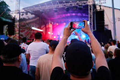 People crowd near stage enjoys musician band's performance