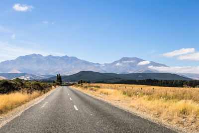 Road amidst landscape against sky