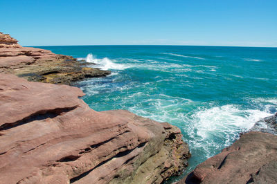 Scenic view of sea against blue sky