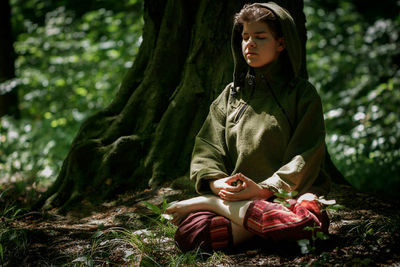 Young woman relaxing in the forest