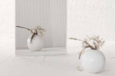 Close-up of white flower vase on table