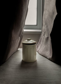 Close-up of coffee cup on sofa at home