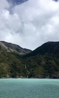 Scenic view of lake and mountains against sky