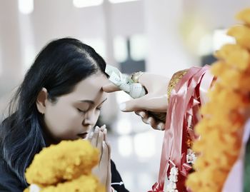 Woman praying in front of idol