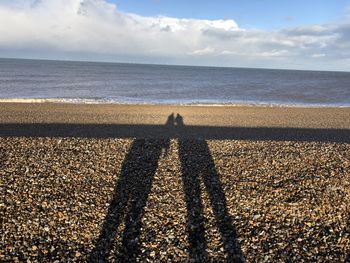 Shadow of people on beach