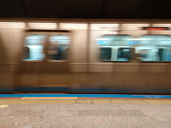 Blurred motion of train at railroad station