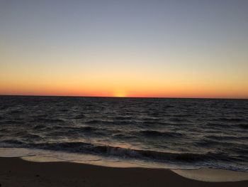 Scenic view of sea against clear sky during sunset