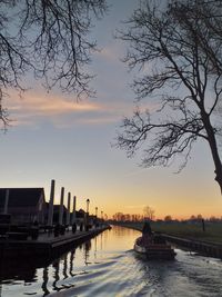 Scenic view of river against sky at sunset