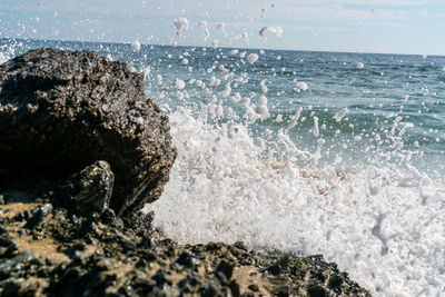 Sea waves splashing on rocks