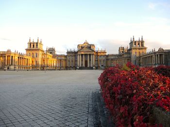 Footpath in front of historical building against sky