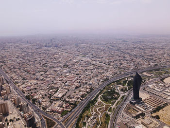 Aerial view of city and buildings against sky