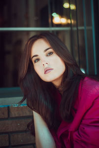 Portrait of young woman sitting outdoors