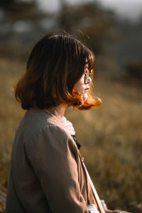 Sad woman sitting on land