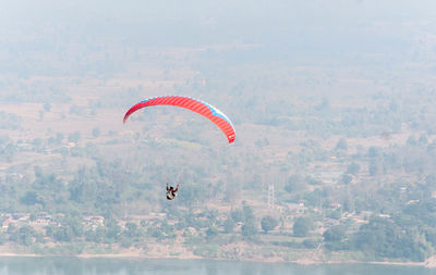 Person paragliding against sky