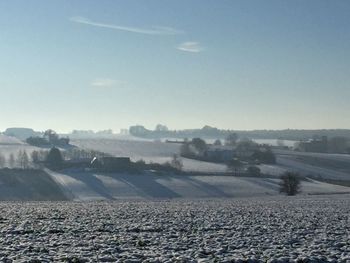 Scenic view of landscape against clear sky during winter