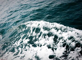 High angle view of waves splashing on shore