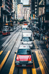 Traffic on city street amidst buildings