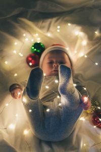 Rear view of boy with christmas lights