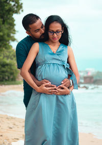 Happy couple standing on land