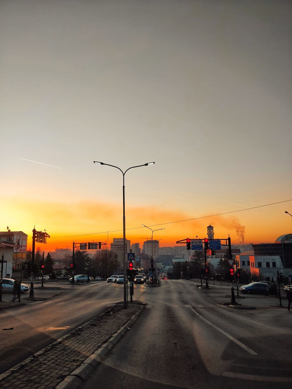 CITY STREET AGAINST SKY DURING SUNSET