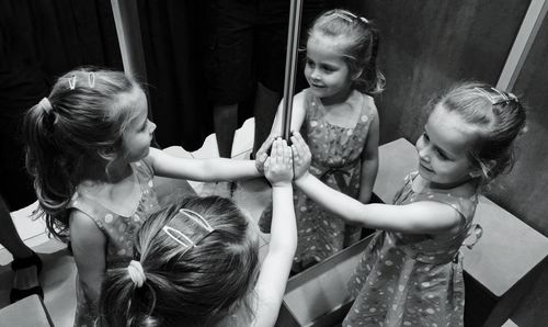 Smiling girl reflecting on mirror