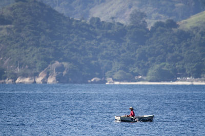 Rear view of man kayaking in sea