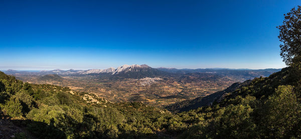 Scenic view of mountains against clear blue sky