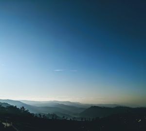 Scenic view of silhouette mountains against sky at sunset