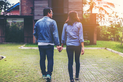 Rear view of couple walking outdoors