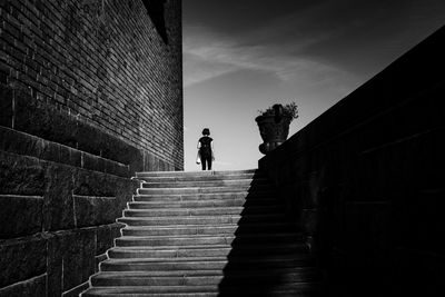 Low angle view of man on staircase against sky