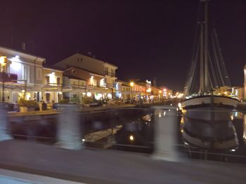 Illuminated boats in water at night