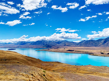 Scenic view of lake and mountains against sky