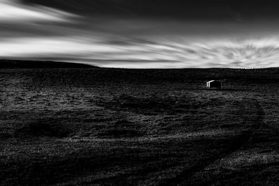 Scenic view of field against storm clouds