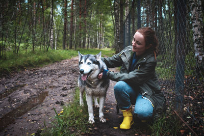 Woman with dog in the forest
