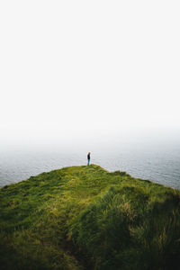 Man looking at sea against sky