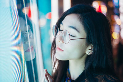 Close-up portrait of young woman looking away