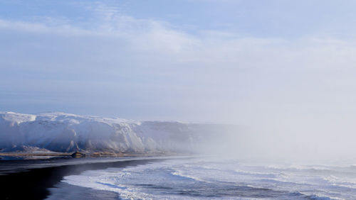 Scenic view of sea against sky during winter