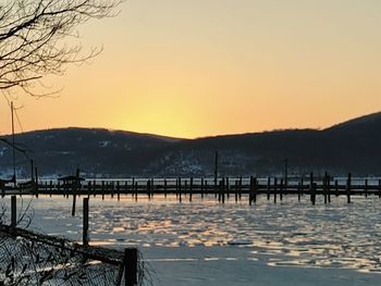 Scenic view of lake against clear sky during sunset