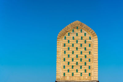 Low angle view of building against clear blue sky