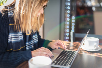 Woman working on table at home