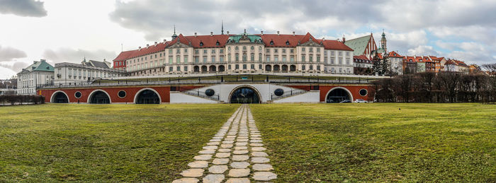 View of arch bridge and buildings against cloudy sky