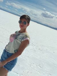 Full length of woman wearing sunglasses on beach