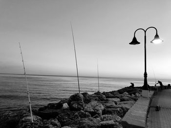 Street by sea against clear sky